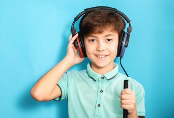 Positive little mixed race boy wearing headphones having hearing exam.audiometry test