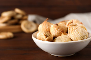 Tasty dried figs on wooden table, closeup. Space for text