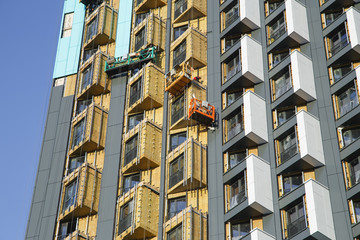 Installation of a ventilated facade in an apartment building under construction. Building insulation