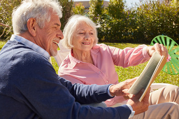 Relaxed senior couple reading a book together