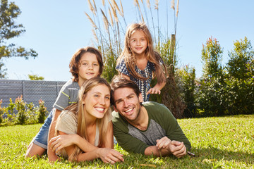 Happy parents and two kids in nature