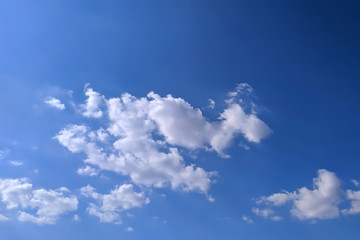 Clouds in the blue sky during the day time. Strong sunlight.