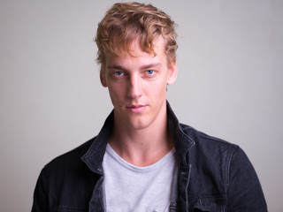 Obraz premium Face of young handsome man with curly hair