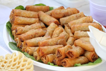 Vietnamese food fry spring rolls display on the leaf close up