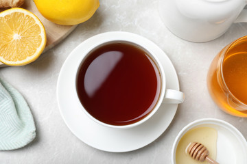 Fototapeta na wymiar Flat lay composition of tea with honey on light grey marble table