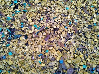 Yellow and blue wood shavings on the brown earth scattered