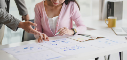 Close-up view of young professional business team brainstorming the project with document and charts