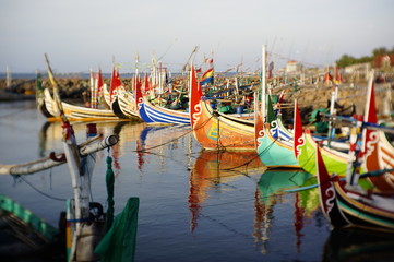 Traditional fishing vessels that still use traditional fishing gear, this boat is made of wood that is resistant to sea water. Fishing boats dock at the seashore.