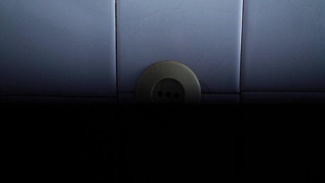 Old socket on the wall. Short circuit. Old power grid. Voltage drop in the room. The light is blinking. Danger. Lighting turn on and off. Power source. House of Horror.