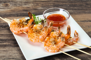 Grilled prawn skewer with sauce
