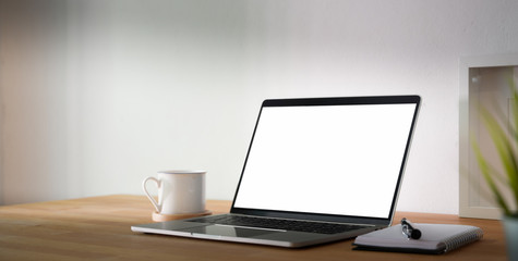 Cropped shot of comfortable workplace with blank screen tablet and office supplies