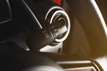 Turn signal switch and on-off switch of headlight on a beside of steering wheel, automotive part concept.