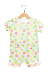 polka dot yellow pink green on white baby clothes bodysuit front view in clothes hanger, isolated on white background.