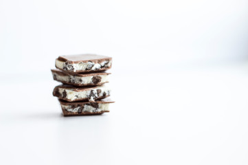 Chocolate slices with white filling on a light background