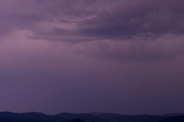 Fototapeta na wymiar Stormy night sky over the mountain plateau background.