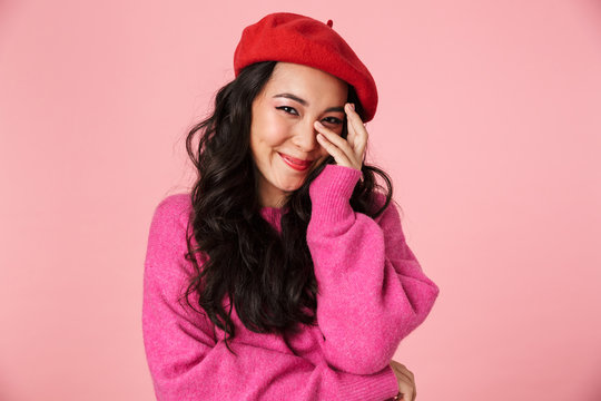 Image of shy beautiful asian girl with long dark hair in beret smiling