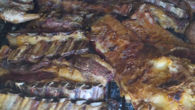 Close up shot of chicken, beef and chorizos grilled in Argentinian parrilla