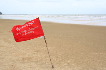 Red flag Warning Strong Current and Dangerous No Swimming in sea on Storm. Red flag flying on beach.