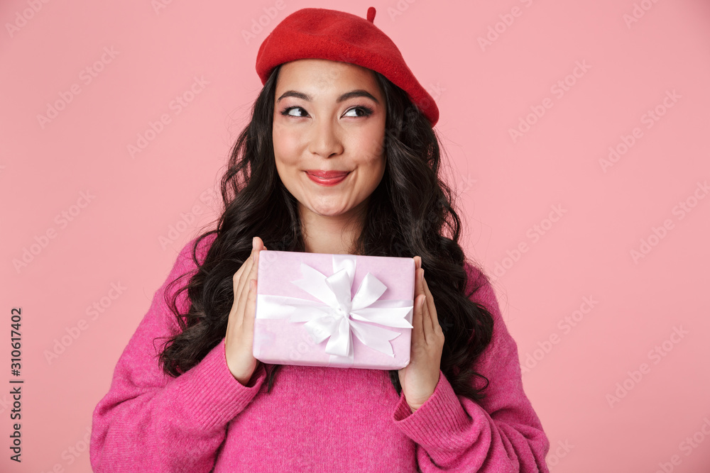 Sticker image of excited beautiful asian girl smiling and holding present box