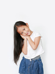 Beautiful caucasian little child girl sleep gesture posing with hands together while smiling with looking at camera isolated over white background.
