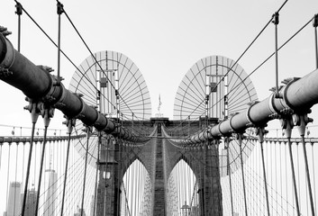 Naklejka premium Black and white detail view of Brooklyn Bridge's suspender cables and wires next to one of its towers. Taken in New York City on September the 28th, 2019