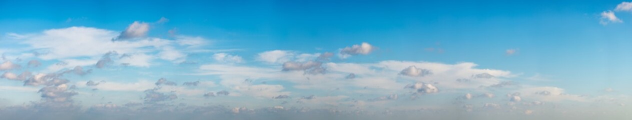 Fantastic clouds against blue sky, panorama