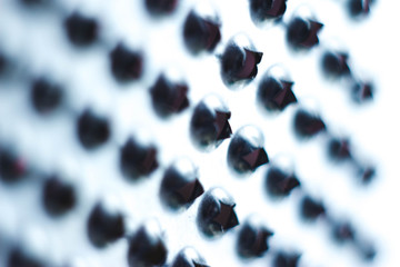 Closeup of a kitchen grater. Kitchen grater close-up, pattern