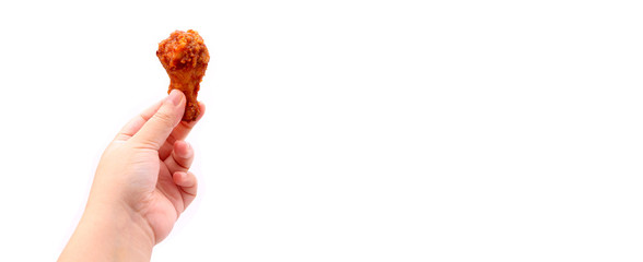  Close up Hand holding  Korean fried chicken  wings isolated on a white background in studio with copy space.