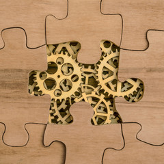 gears under the details of a puzzle made of natural wood. Concept business idea. teamwork,...