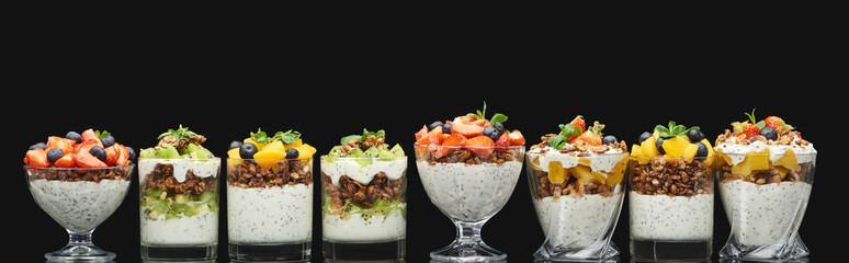 fresh granola with fresh fruits and berries isolated on black, panoramic shot