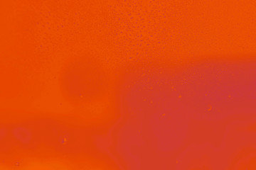 Bright red orange lush lava gradient background with drops of water