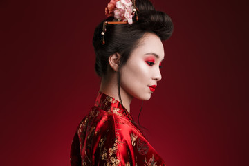 Image of charming geisha woman in japanese kimono looking downward