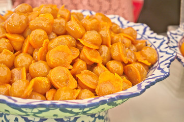 Delicious golden Thai jackfruit seed dessert recipe calls in Thai name is Khanom Med Khanoon is traditional snack dessert in Thai cuisine menu made by mung bean paste coated egg yolks in hot syrup