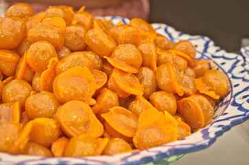 Delicious golden Thai jackfruit seed dessert recipe calls in Thai name is Khanom Med Khanoon is traditional snack dessert in Thai cuisine menu made by mung bean paste coated egg yolks in hot syrup