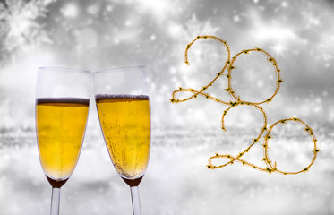 Happy new 2020 year! Elegant gold text of sparkling lights and champagne