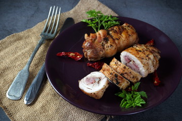 Chicken roll on a dark plate. Healthy diet
