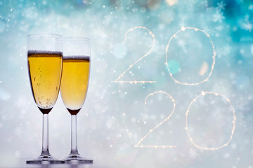 Happy new 2020 year! Elegant gold text of sparkling lights and champagne
