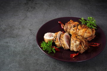 Chicken roll on a dark plate. Healthy diet