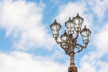 Fototapeta na wymiar Florence old-styled street lamp on blue sky background