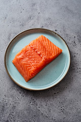Portion of fresh raw filleted salmon on a plate