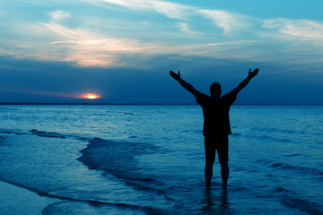 Silhouette of Man Raising His Hands or Open arms when sun rising up