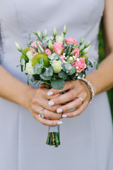Obraz na płótnie Canvas Bright delicate bouquet of the bride in the hands of the bride