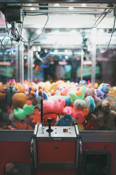 Claw Machine Arcade Game Filled With Brightly Colored Stuffed Toys