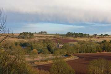 Fototapeta premium The small hamlet of Lunan nestled into the rolling Fields and Countryside of Angus on the East Coast of Scotland.