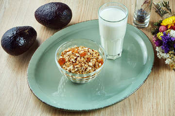 Granola in a bowl with greek yogurt on a gray plate on a wooden background. Delicious, healthy and nutritious breakfast. Fitness nutrition. Food photo background. Close up view
