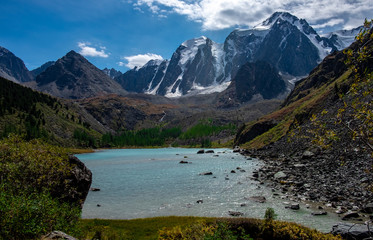 Mountain lake on the background of snow-capped peaks in the Altai Republic.