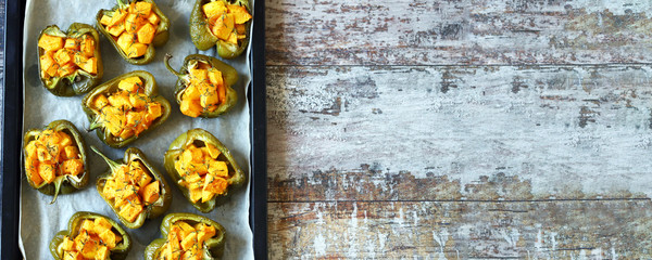 Paprika peppers stuffed with pumpkin. Baked paprika with pumpkin. Vegan lunch. Autumn food. Selective focus. Macro.