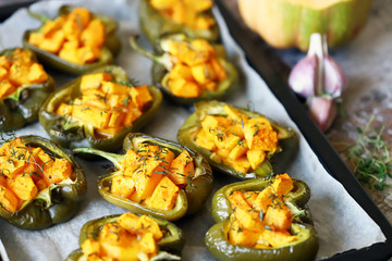 Paprika peppers stuffed with pumpkin. Baked paprika with pumpkin. Vegan lunch. Autumn food. Selective focus. Macro.