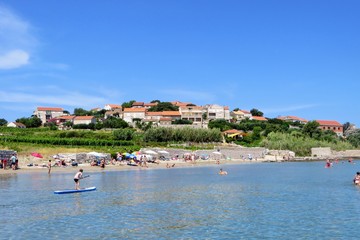Locals and tourists enjoying a beautiful summer day along the sandy beaches of Lumbarda Beach on Korcula Island, Croatia