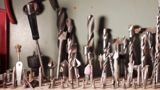 Man&rsquo;s hand choose one drill bit over many others